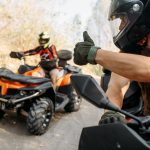 ATV rider showing thumbs up to his partner