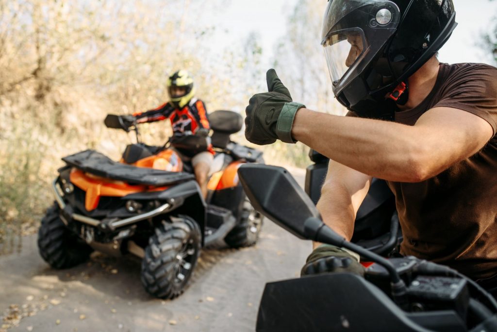 ATV rider showing thumbs up to his partner | Winter-Dent ATV rider showing thumbs up to his partner
