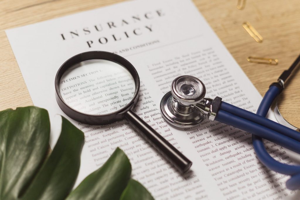 Health insurance. Doctor's stethoscope, magnifier and health insurance contract. | Winter-Dent Health insurance. Doctor's stethoscope, magnifier and health insurance contract.